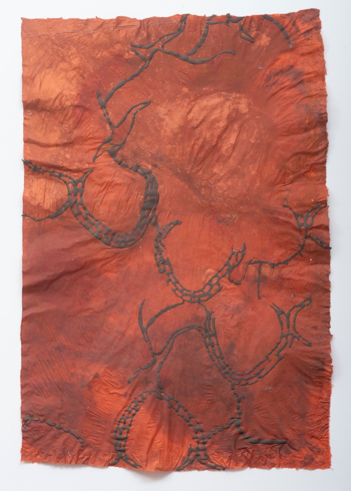 brown linear shapes on rust colored paper
