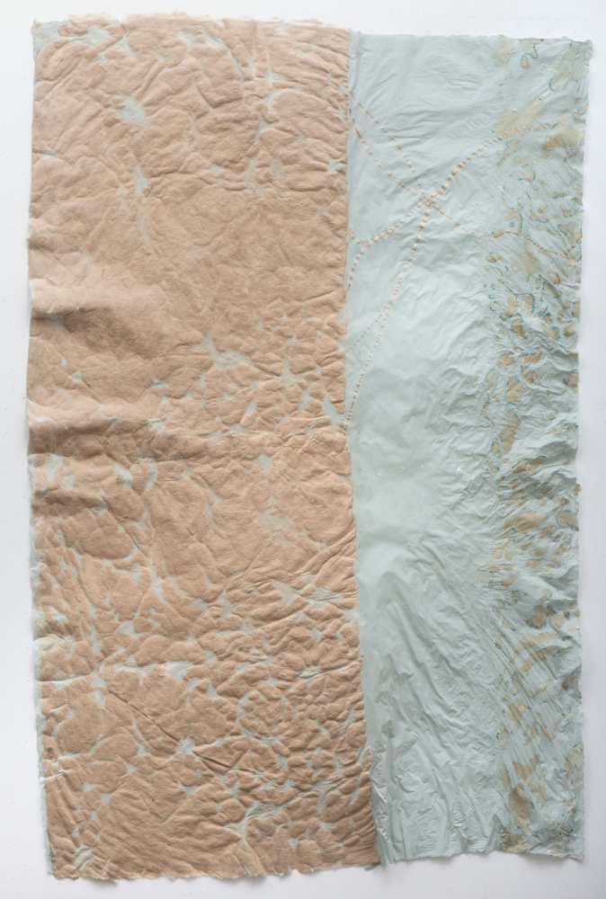 puckered brown texture on left side of pale blue paper