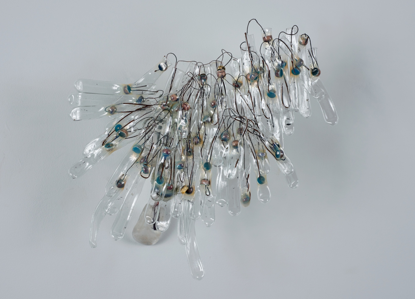 Wall sculpture of melted glass test tubes