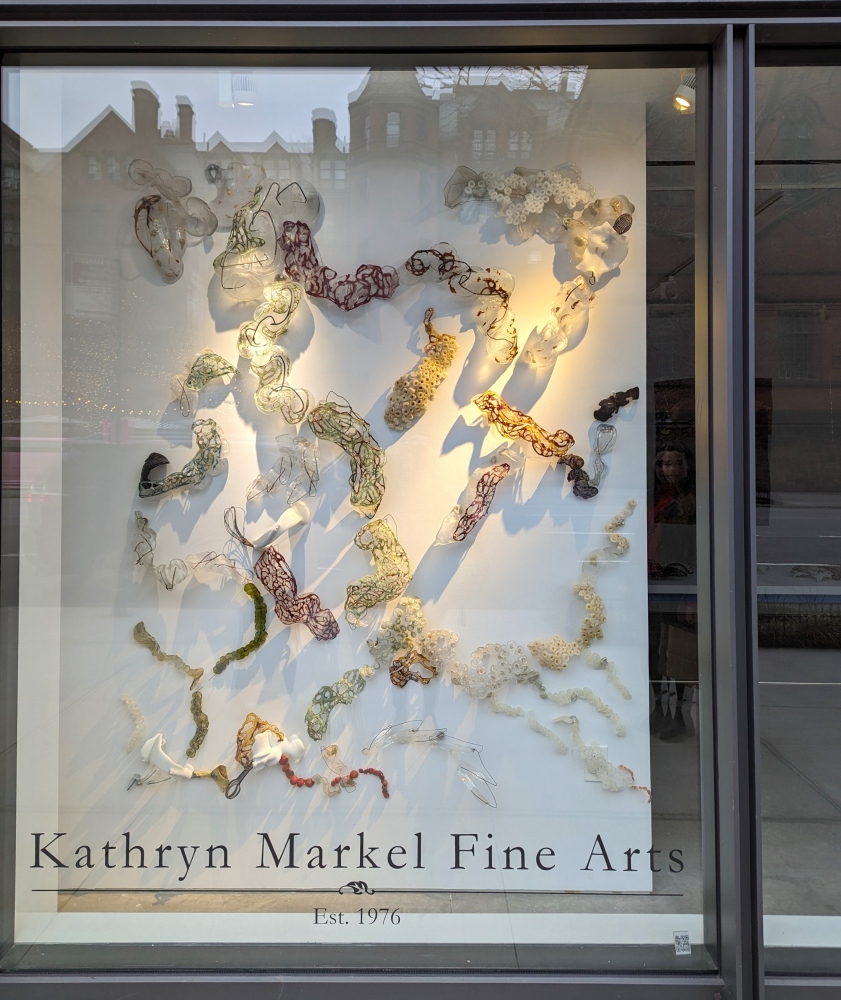 curvy glass forms abstracting showing tree roots in the window