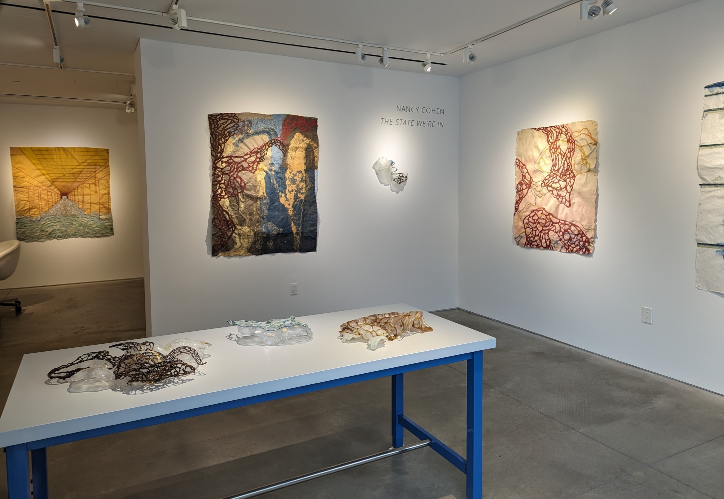 installation shot of exhibition with 3 drawings and 4 sculptures