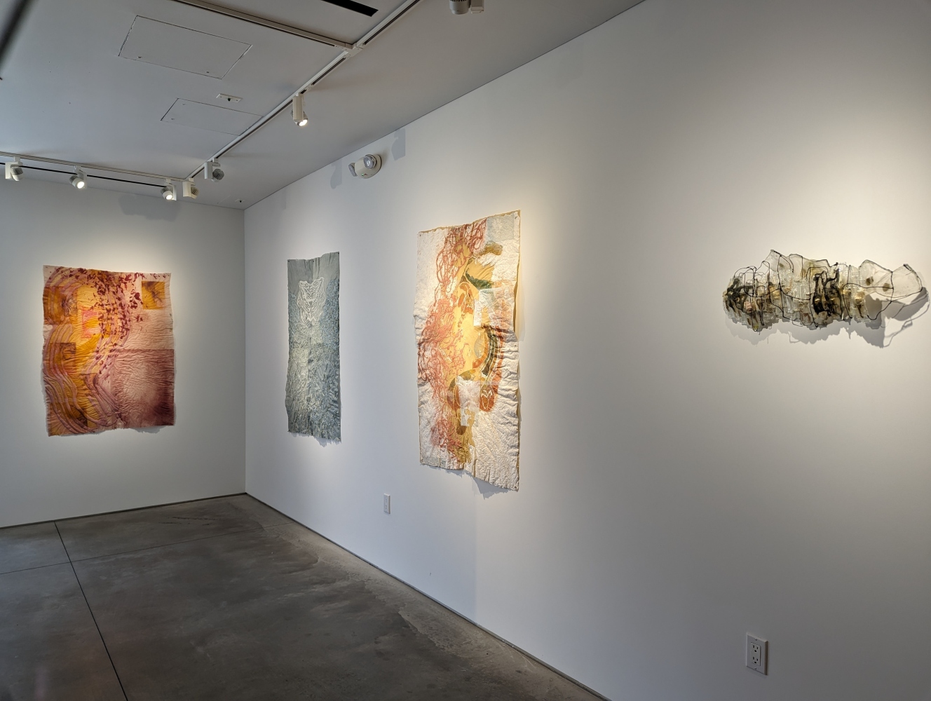 installation shot of exhibition with 3 drawings and 1 sculpture