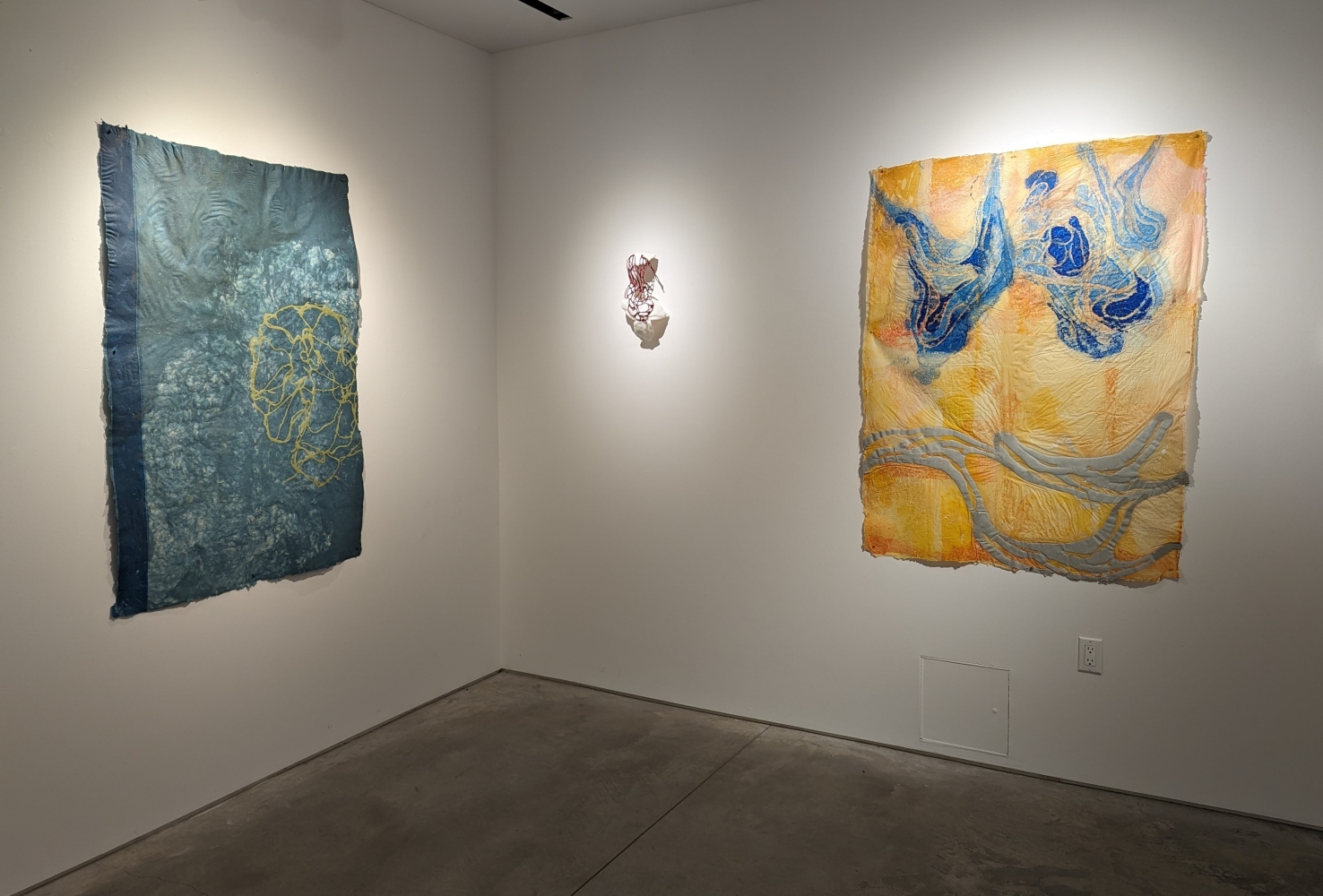 installation view of two drawings and one wall sculpture