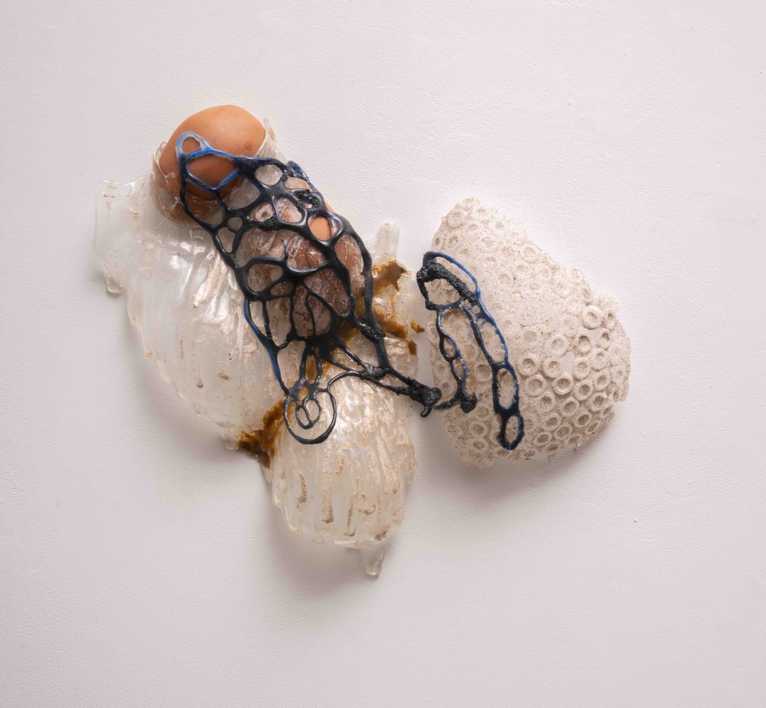 Glass wall sculpture of organic form and blue lines