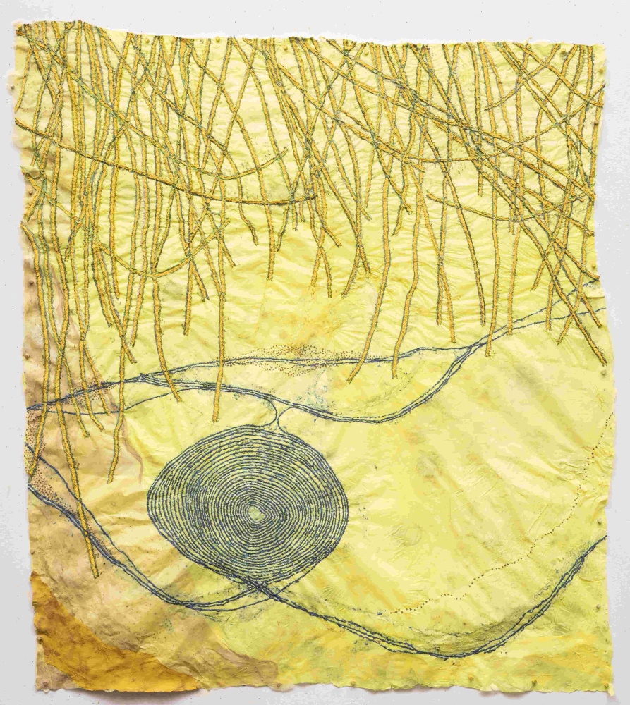 yellow handmade paper drawing with blue web shape in the center