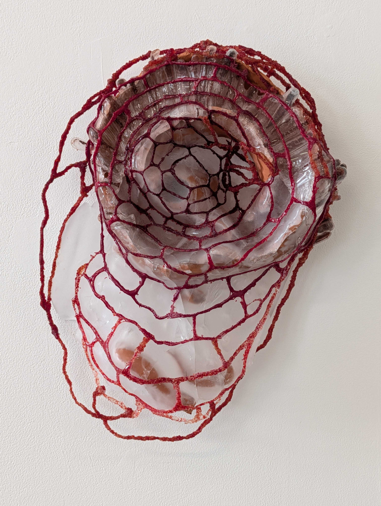 glass and clay sculpture of spider web