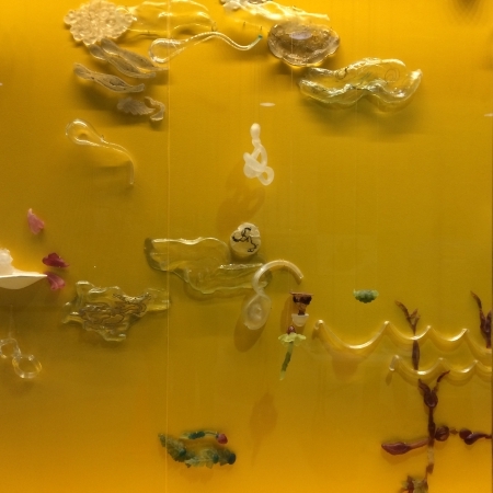 yellow wall with glass shapes evoking buddhist iconography