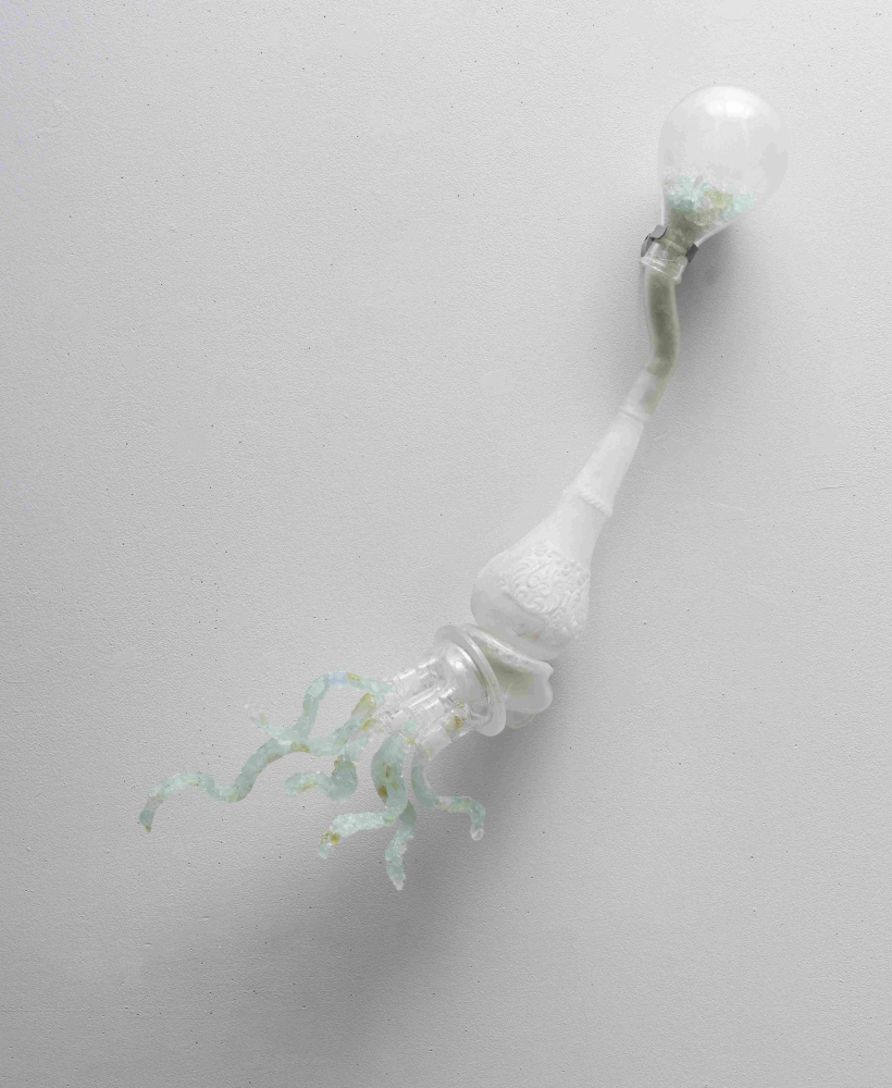 glass wall sculpture that looks like a shooting rocket
