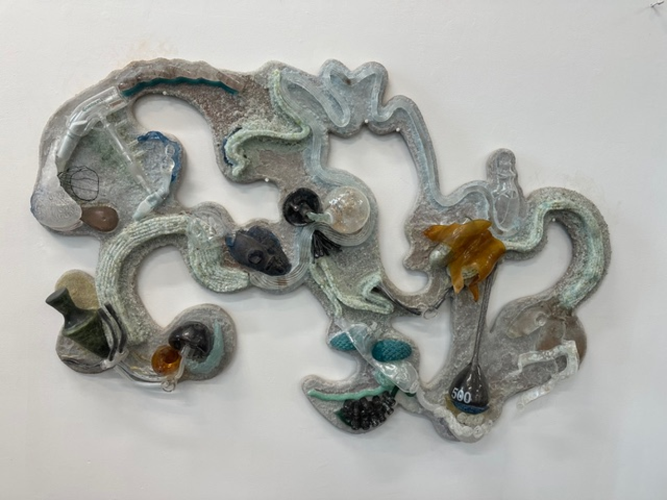 wall installation of organic glass elements mounted on wood