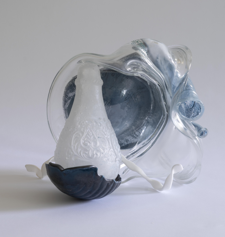 Glass tabletop sculpture with melted bottles