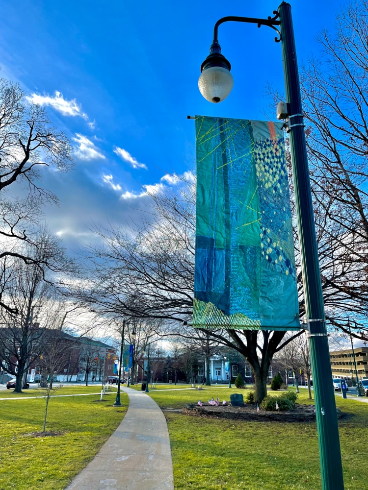 one banner in the foreground depicting sky and water