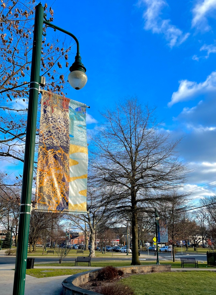 yellow and orange banner in the foreground in park in summit nj